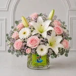 A round glass-vase arrangement featuring approximately 9 pale-pink roses